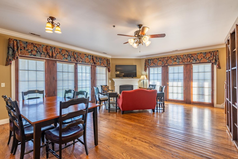 Dining room featuring ceiling fan, ornamental molding, and hardwood / wood-style flooring