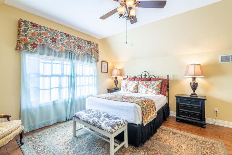 Bedroom featuring hardwood / wood-style flooring, ceiling fan, and vaulted ceiling