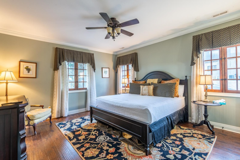 Bedroom featuring ceiling fan, dark hardwood / wood-style flooring, and ornamental molding