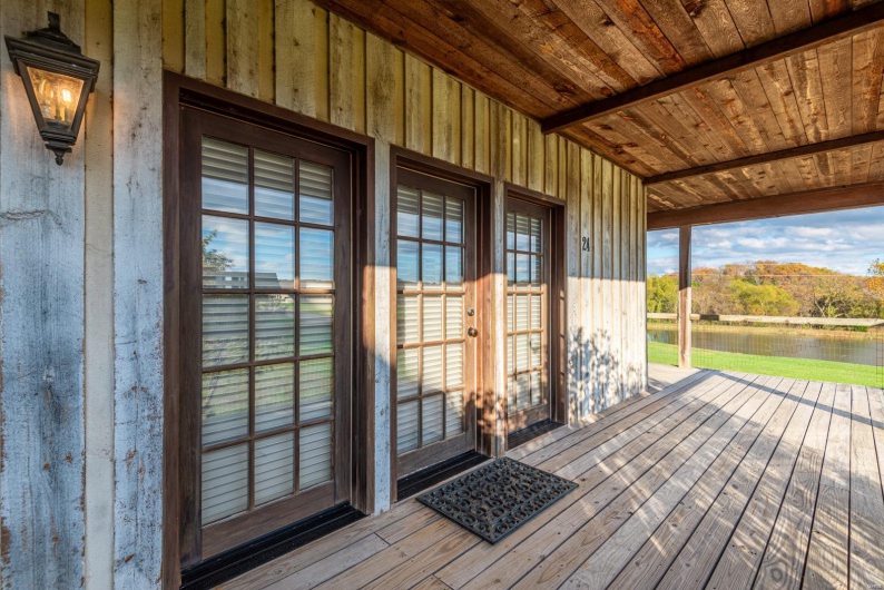 Wooden deck featuring a water view and french doors