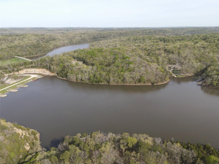 Bird's eye view with a water view and a wooded view