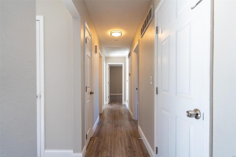 Hall with dark wood-type flooring