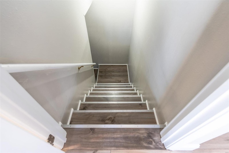 Staircase featuring  / wood-style floors