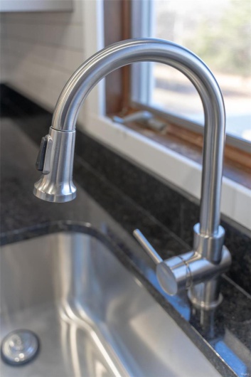 Room details with dark stone countertops and sink