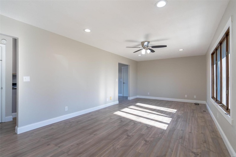 Empty room featuring wood-style flooring and ceiling fan