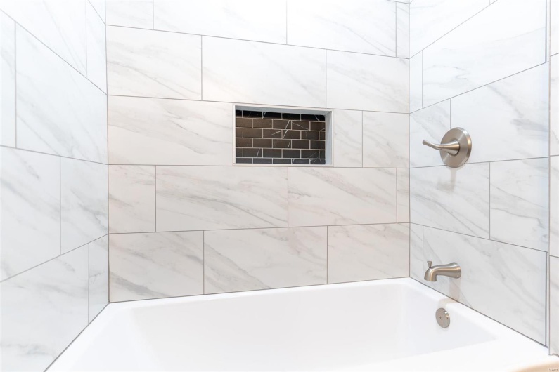 Bathroom featuring tiled shower / bath
