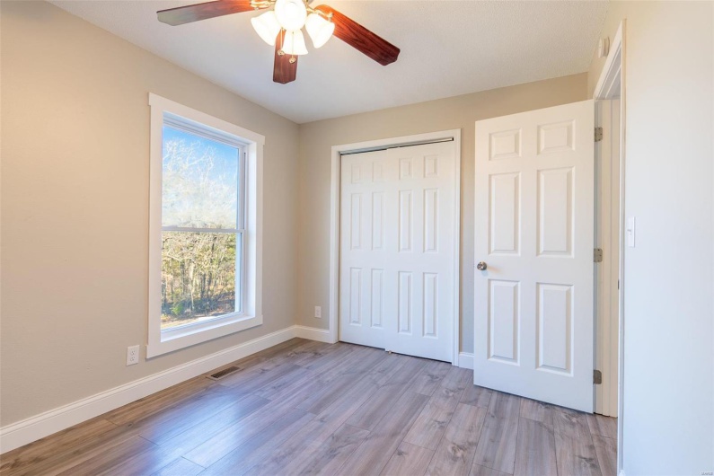Unfurnished bedroom with light wood-type flooring, a closet, and ceiling fan