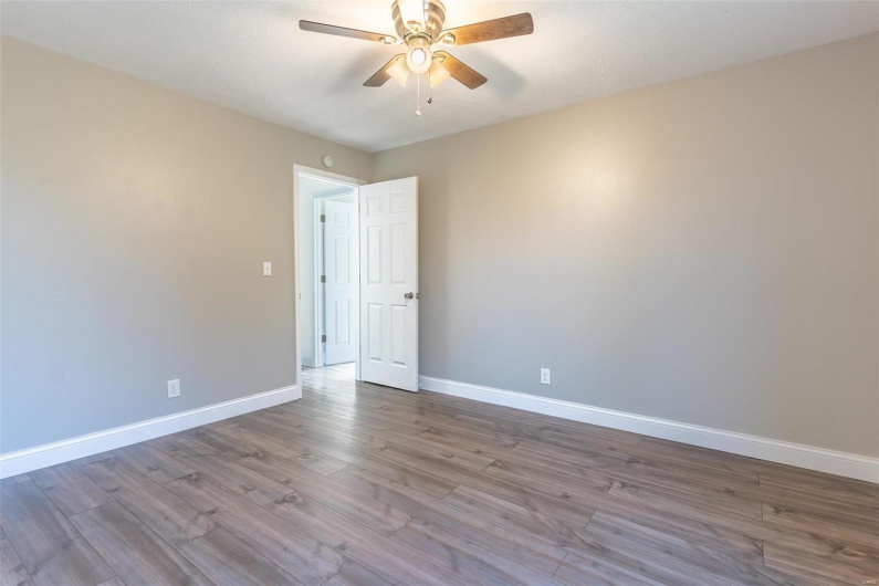 Spare room featuring ceiling fan and light hardwood / wood-style floors