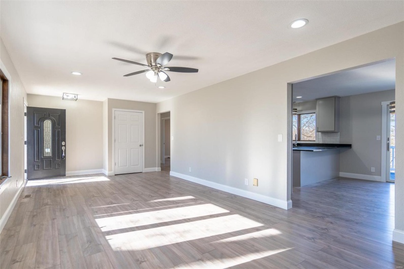 Unfurnished living room featuring hardwood / wood-style floors and ceiling fan