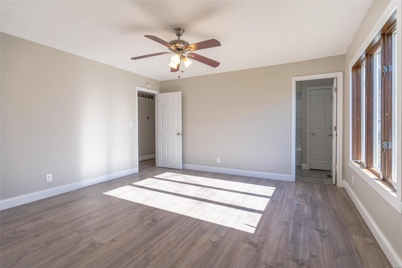Unfurnished bedroom featuring  wood-style flooring and ceiling fan