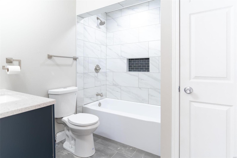 Full bathroom with vanity, toilet, and tiled floor ,shower / bath