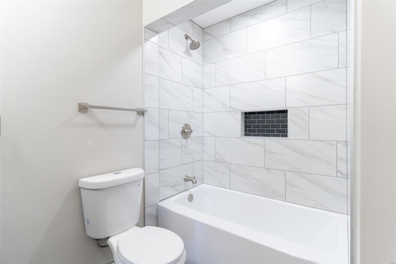 Bathroom featuring toilet and tiled shower / bath