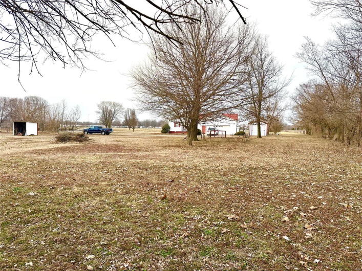 View of yard featuring a storage shed and an outdoor structure
