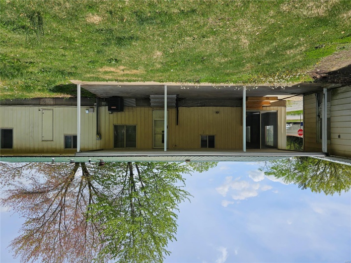Back of property with entry steps, a yard, central AC, and metal roof