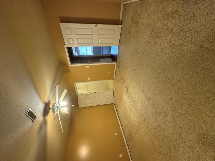 Unfurnished bedroom featuring visible vents, a ceiling fan, a closet, baseboards, and carpet flooring