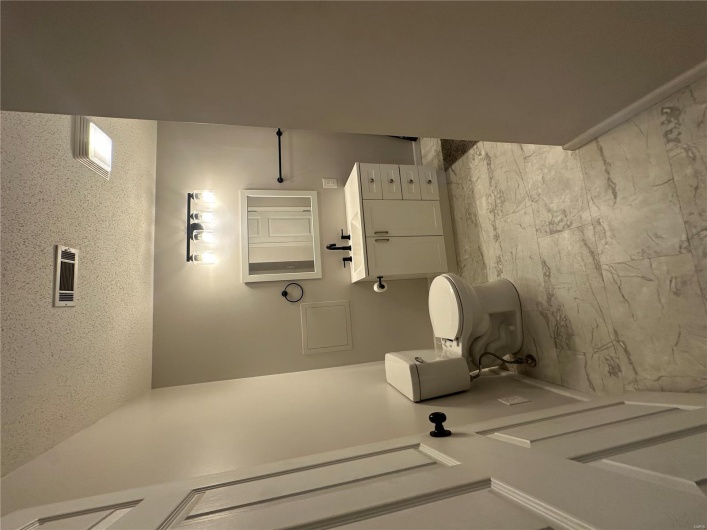 Bathroom featuring visible vents, marble finish floor, baseboards, and toilet