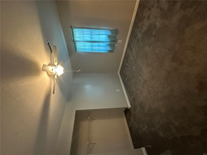 Unfurnished bedroom with dark carpet, a textured ceiling, baseboards, and visible vents