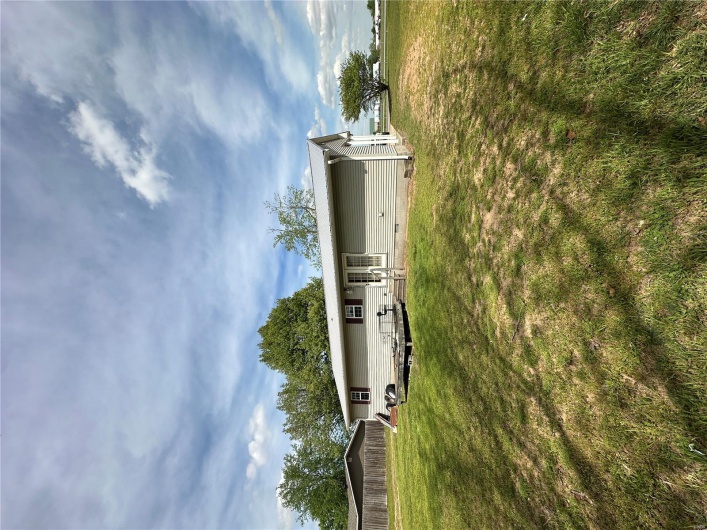 Back of property featuring a lawn