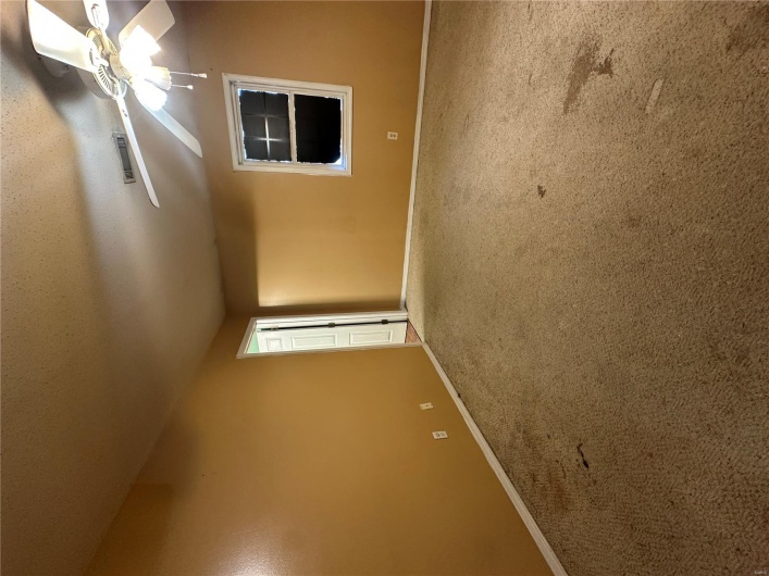 Carpeted spare room with ceiling fan, baseboards, and visible vents
