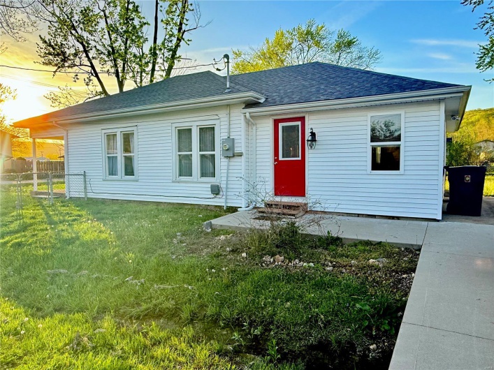 Single story home featuring fence, a lawn, a shingled roof, and entry steps