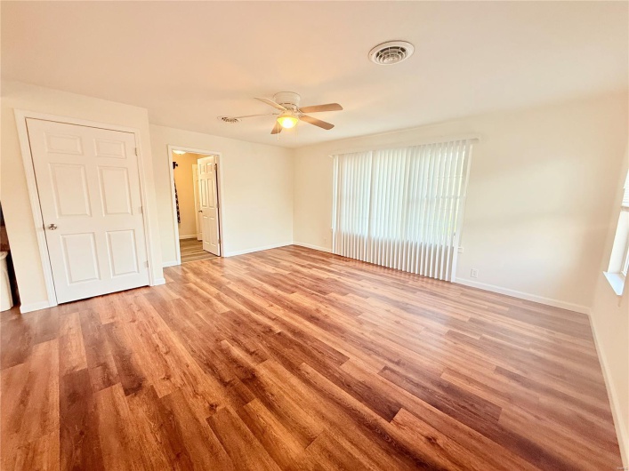 Unfurnished bedroom with visible vents, light wood finished floors, and baseboards