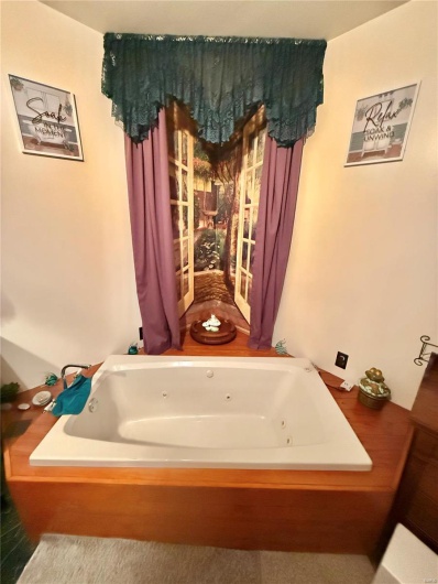 Full bathroom featuring a whirlpool tub