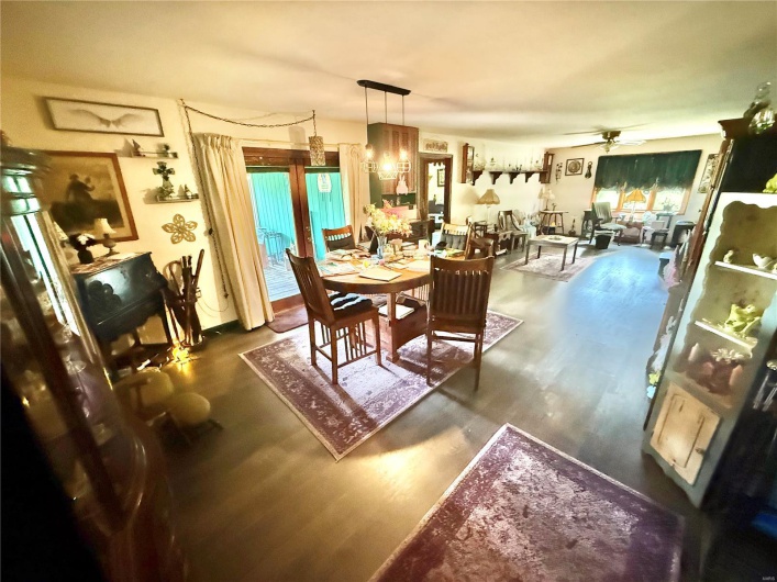 Dining room featuring dark wood-type flooring and ceiling fan