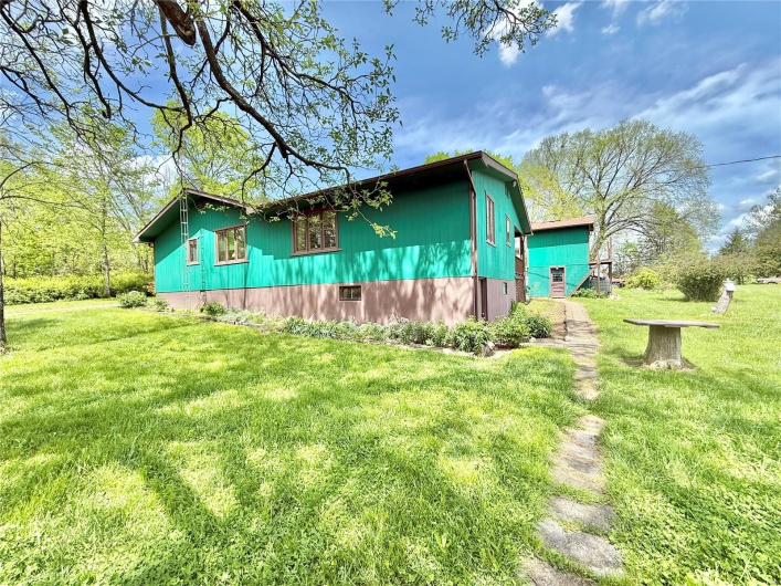View of side of property with a yard