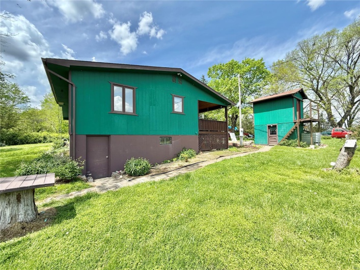 View of side of property with a yard