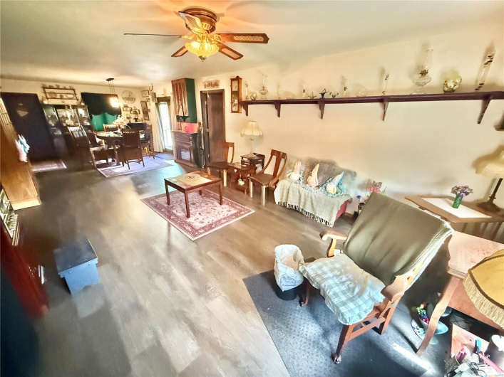 Living area with a ceiling fan and wood finished floors