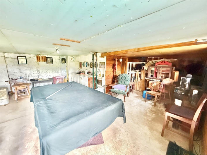 Game room featuring unfinished concrete flooring