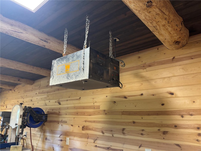 Details with wooden walls and a heating unit