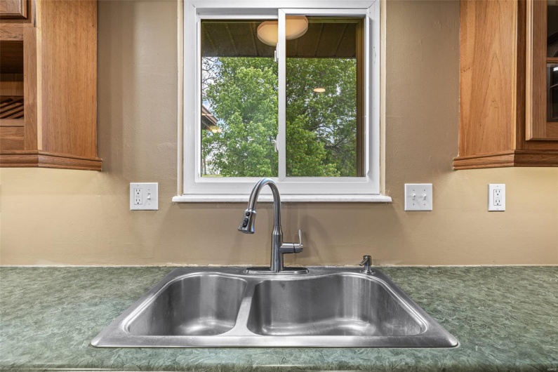 Interior details with brown cabinetry and a sink