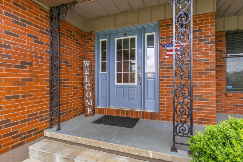 Entrance to property featuring brick siding