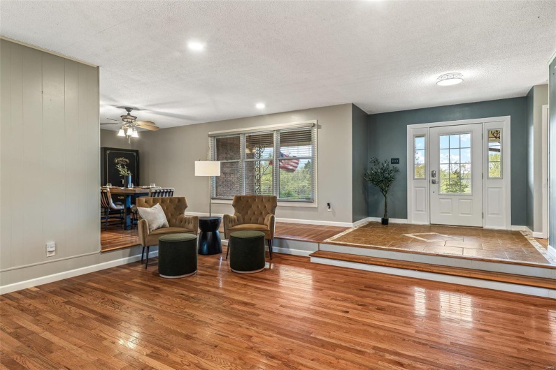 Entryway featuring baseboards, wood finished floors, and a textured ceiling