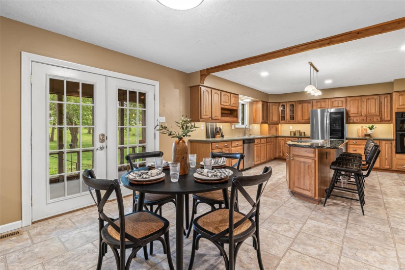 Dining space featuring french doors, visible vents, baseboards, recessed lighting, and stone finish flooring