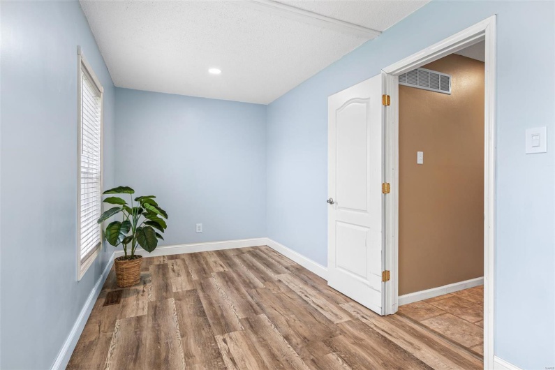 Unfurnished room with baseboards, wood finished floors, visible vents, and recessed lighting