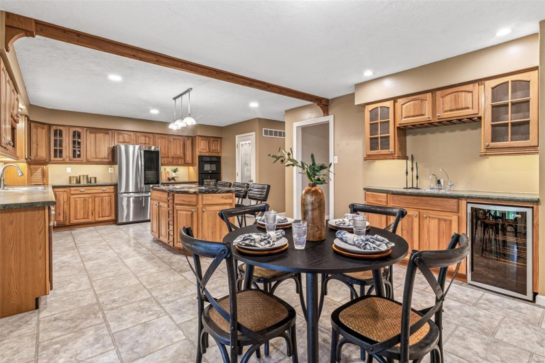 Dining space with recessed lighting, wet bar, beverage cooler, and visible vents