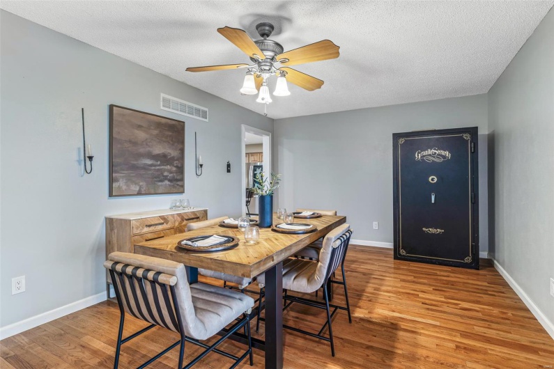 Dining space featuring baseboards, wood finished floors, and visible vents