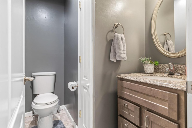 Bathroom with baseboards, toilet, and vanity