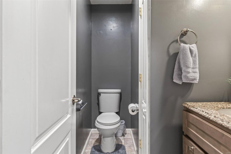 Bathroom featuring toilet, vanity, and baseboards