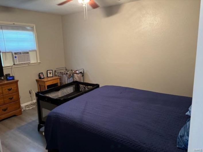 Bedroom featuring wood-type flooring and ceiling fan