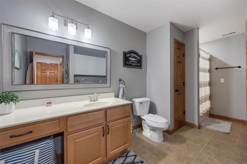 Full bath with toilet, vanity, baseboards, tile patterned flooring, and a shower with shower curtain