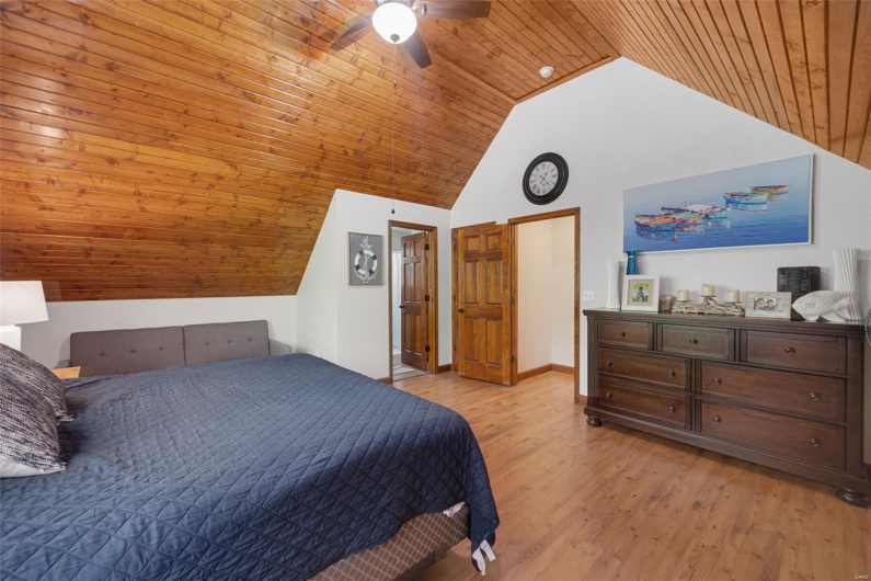 Bedroom featuring wooden ceiling, high vaulted ceiling, light wood-type flooring, ceiling fan, and baseboards