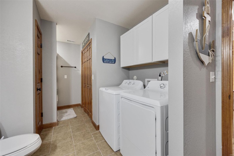 Laundry room featuring washer and clothes dryer and light tile patterned floors