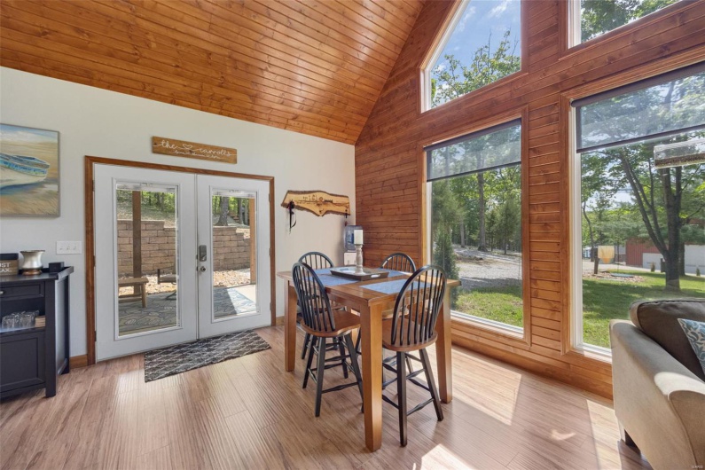Dining area featuring high vaulted ceiling, french doors, wood ceiling, and wood finished floors