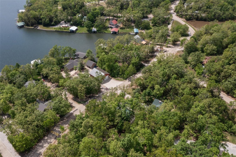 Aerial view of property and surrounding area with a large body of water
