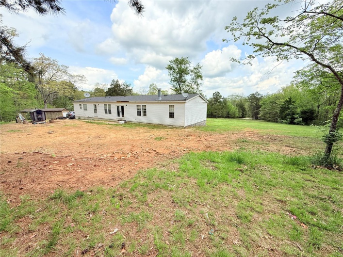 Back of house with a lawn