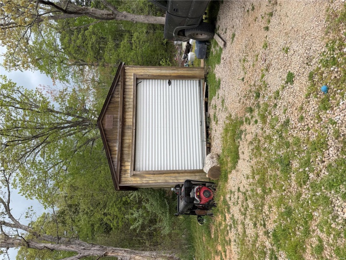 Detached garage with dirt driveway