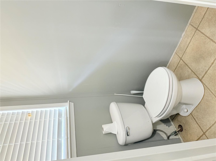 Bathroom featuring toilet and baseboards